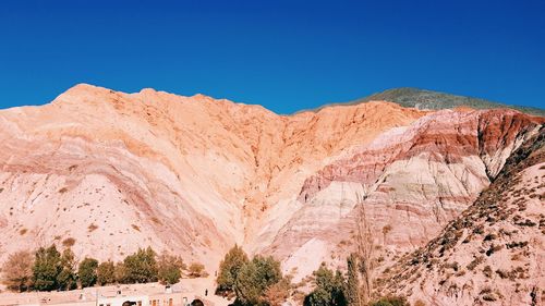 Scenic view of mountain against blue sky