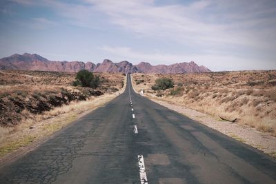 Empty road along countryside landscape