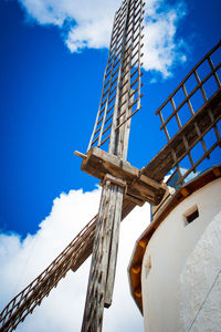 Low angle view of windmill against sky