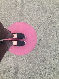 Low section of woman standing on road