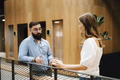 Coworkers talking at corridor