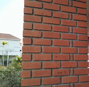 Close-up of brick wall against building