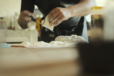 Cropped hand preparing food