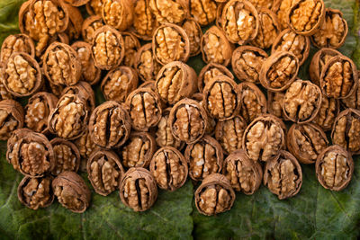 Walnuts in shell heap pattern as organic food background