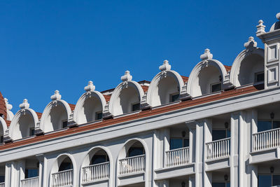 Low angle view of building against clear blue sky