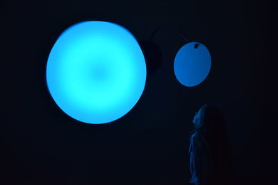 Close-up of balloons against blue sky at night