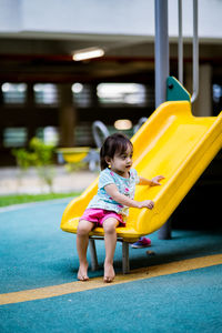 Full length of girl playing on slide