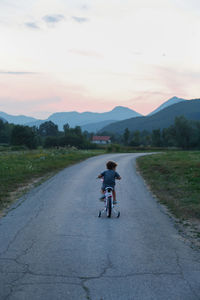 Little boy riding a bicycle in the mountains