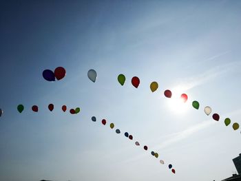 Low angle view of hot air balloons flying in sky