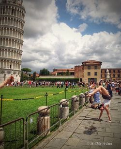 People in front of buildings against sky