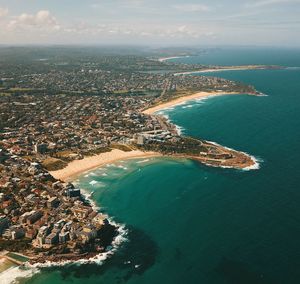 High angle view of sea and cityscape against sky