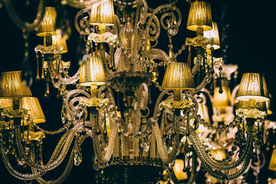 Close-up of illuminated chandelier hanging at store