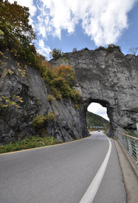 Road amidst rock formation against sky