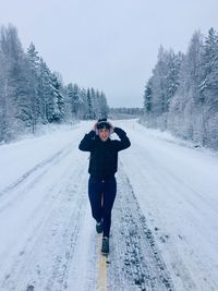 Full length of man standing on snow covered field