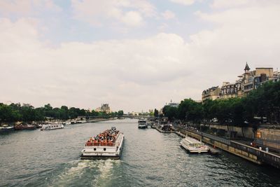 Passenger craft sailing on seine river against sky