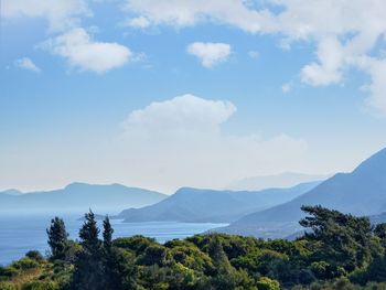 Scenic view of mountains against cloudy sky