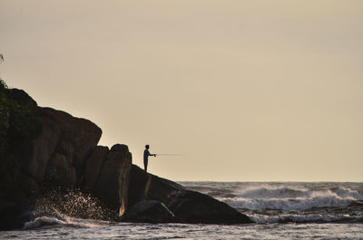 Side view of a man fishing at sea