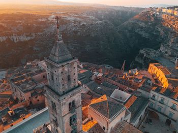 Aerial view of buildings in city during sunset