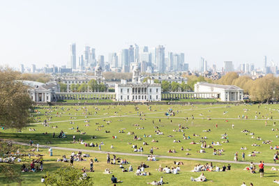 People in park with buildings in background