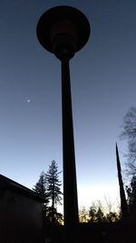 Low angle view of silhouette trees against sky