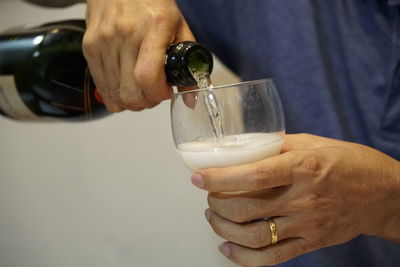 Midsection of man drinking glass