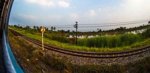 Train on railroad track against sky