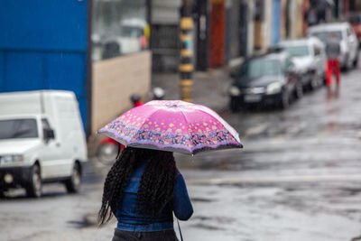 A person walking with an umbrella on a rainy morning