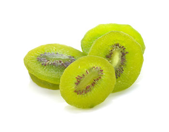 Close-up of green fruit against white background