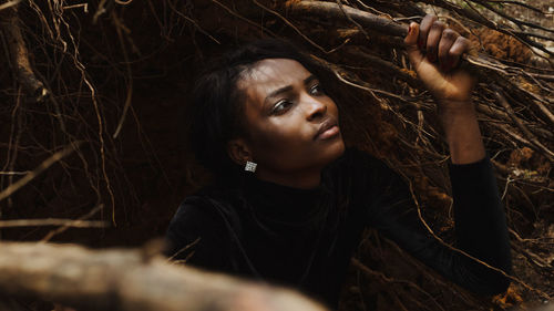 Close-up of young woman looking away at farm