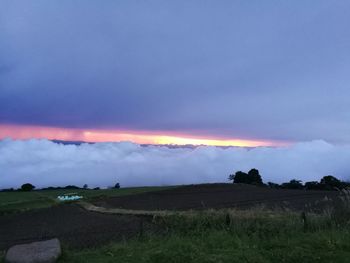 Scenic view of field against sky at night