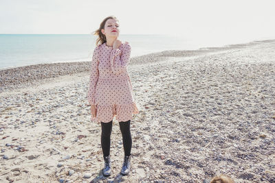 Full length of woman standing on beach