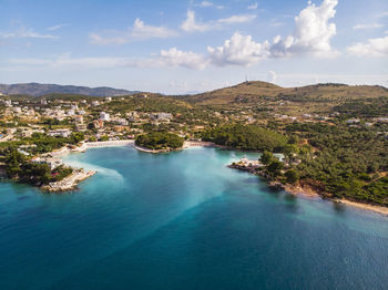 High angle view of sea and mountains against sky