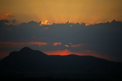 Scenic view of silhouette mountains against romantic sky at sunset