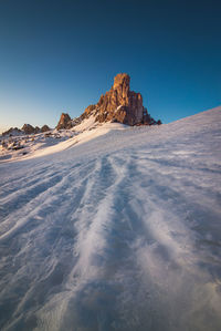 Scenic view of snowcapped mountains against clear blue sky