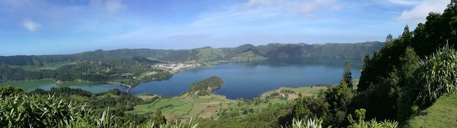 Panoramic view of lake and trees against sky