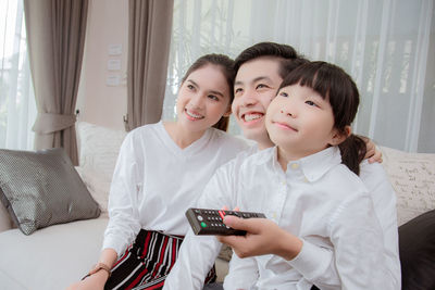 Portrait of a smiling young woman using mobile phone