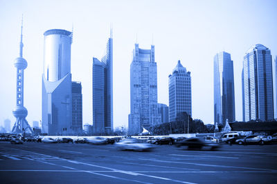 Modern buildings in city against clear sky