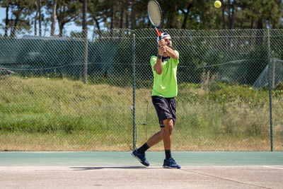 Full length of woman playing tennis