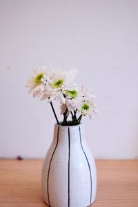 Close-up of white flower vase on table