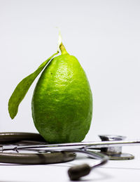 Close-up of lemon on table against white background