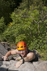 Man climbing up steep rock face in south wales