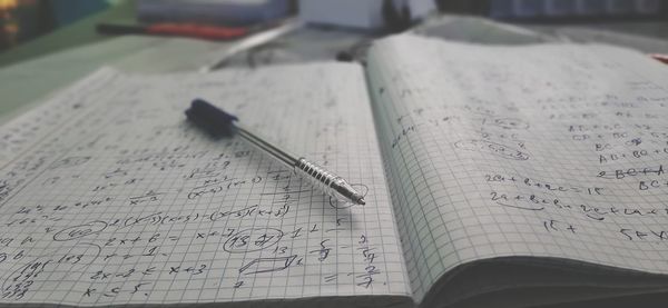 High angle view of pen and book on table