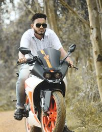 Man riding motorcycle on field