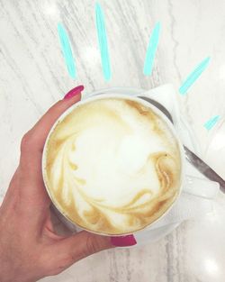 Close-up of hand holding coffee cup