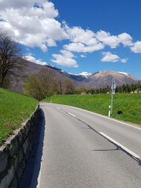 Road by mountain against sky