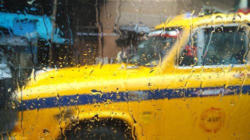 Taxi seen through wet car window