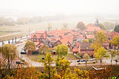 High angle view of houses and trees in city