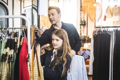 Father and daughter shopping in boutique