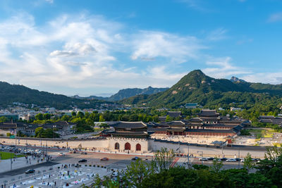 High angle view of buildings and mountains against sky