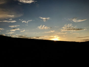 Silhouette landscape against sky during sunset